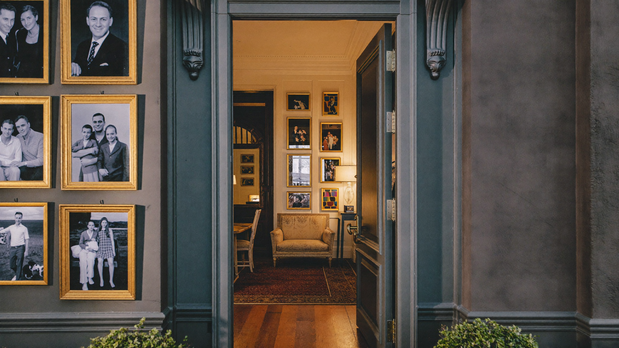 A welcoming luxury portrait studio entrance with warm light and framed portraits