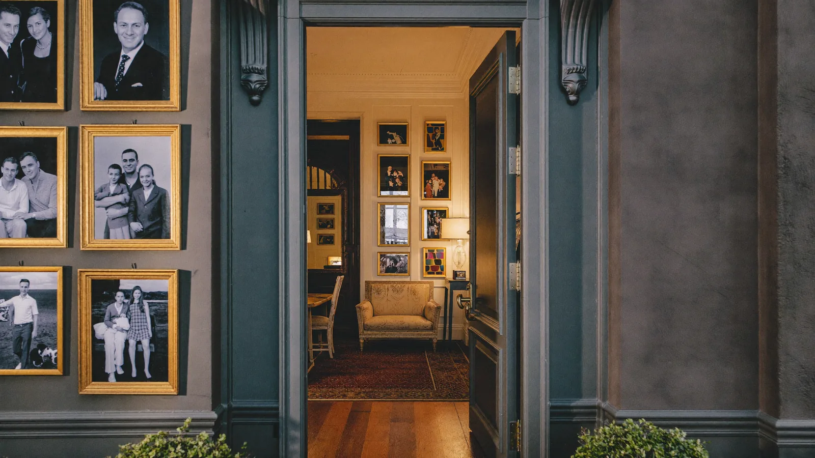 A welcoming luxury portrait studio entrance with warm light and framed portraits