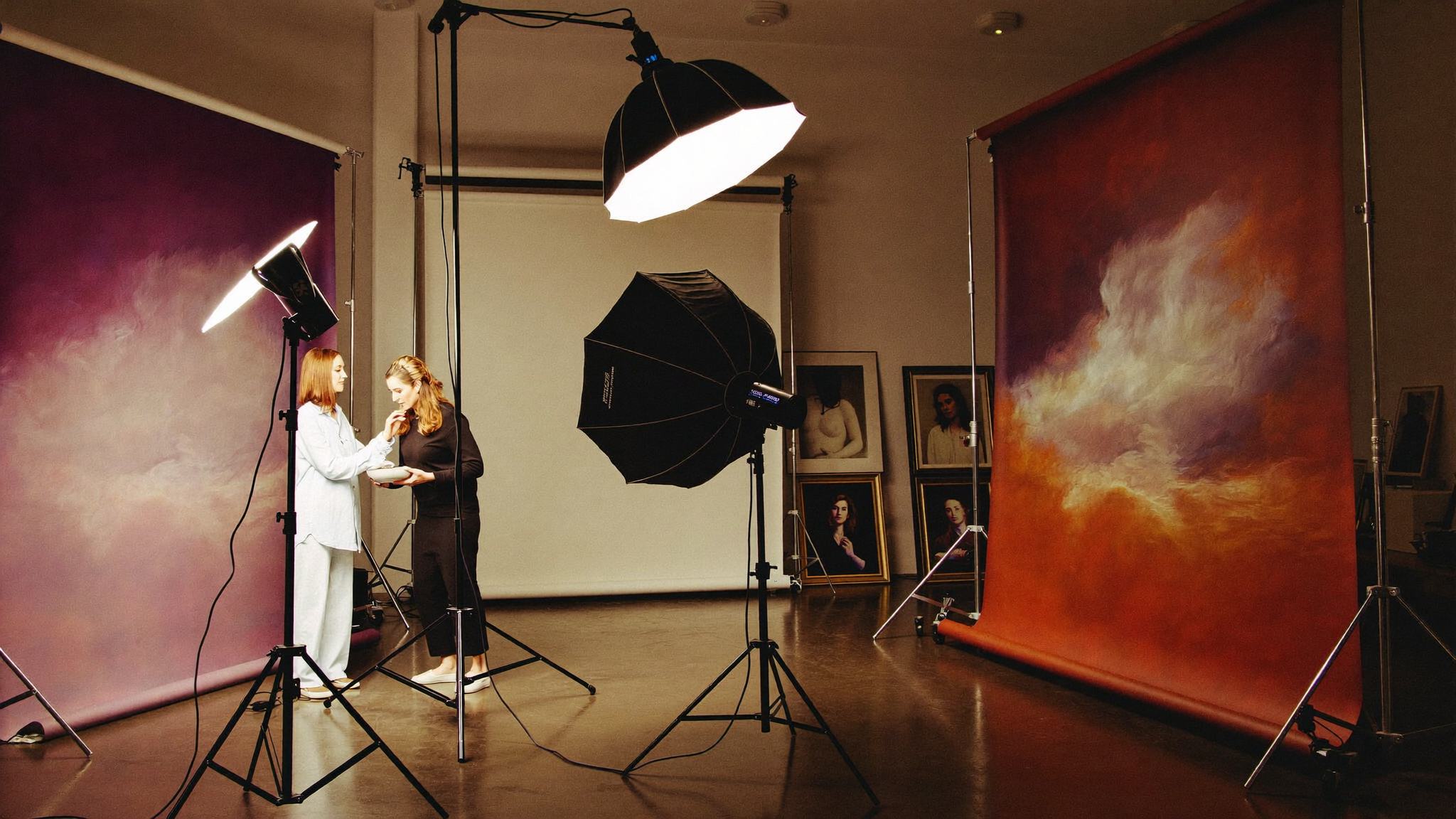 A luxury portrait studio production day: softboxes, painterly backdrops and gallery-framed portraits